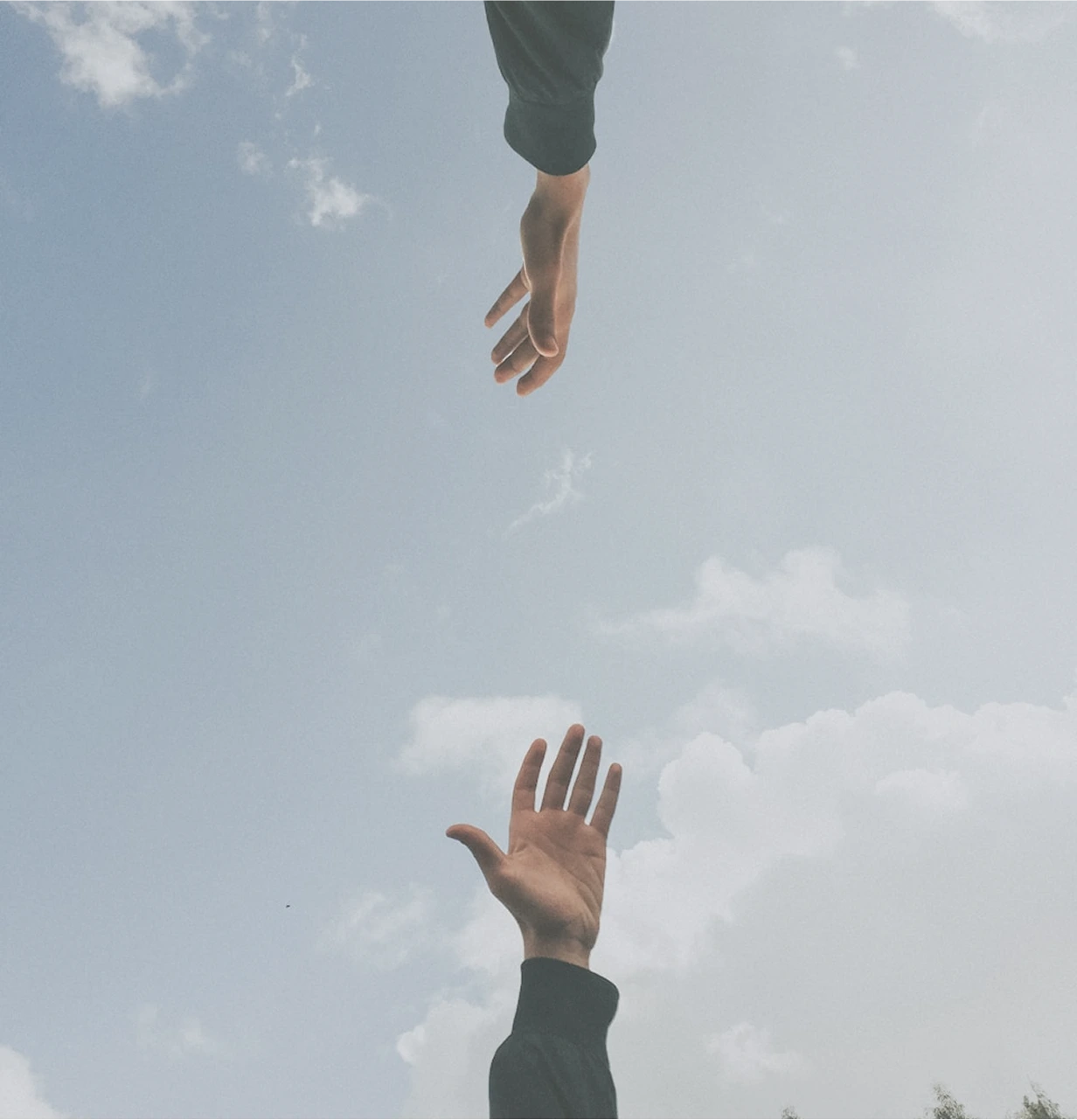 Two Hands Reaching To Each Other